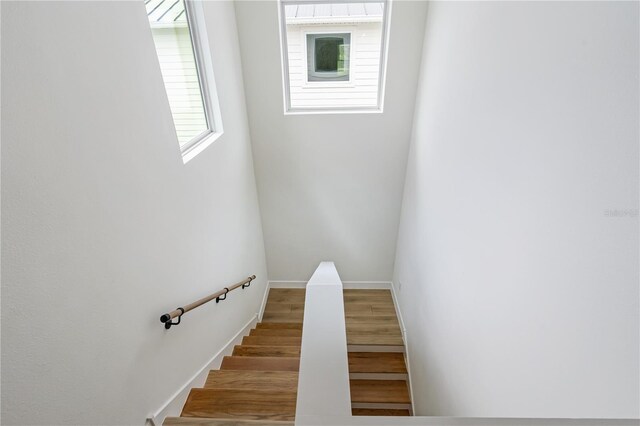 stairs with baseboards and wood finished floors