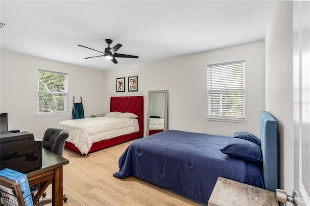 bedroom with ceiling fan, light wood-type flooring, and visible vents
