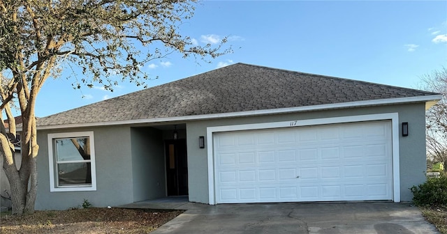 ranch-style home featuring a shingled roof and stucco siding