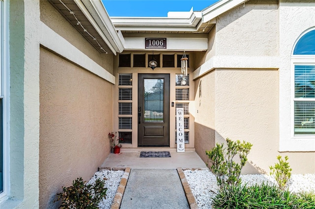 doorway to property with stucco siding