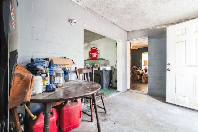 interior space with concrete block wall and concrete flooring