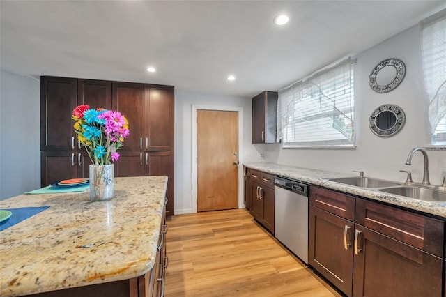 kitchen featuring light wood-style flooring, light stone counters, stainless steel dishwasher, a sink, and recessed lighting