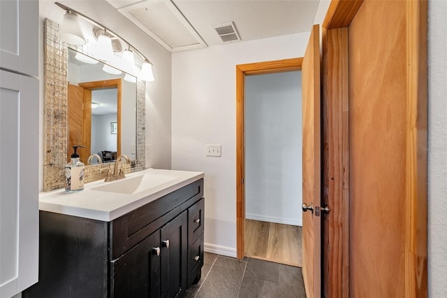 bathroom with baseboards, visible vents, and vanity