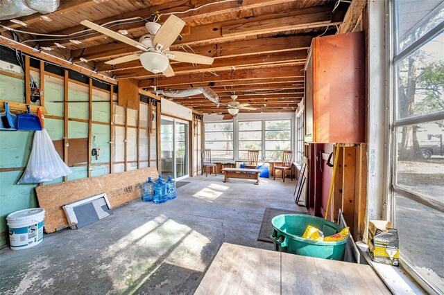 unfurnished sunroom with a ceiling fan