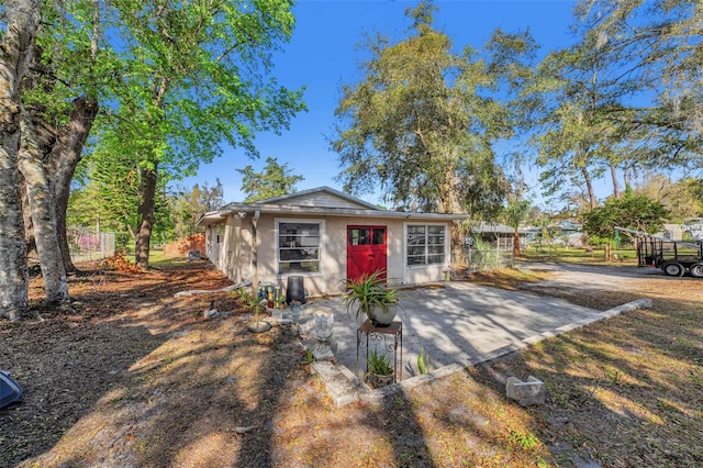 view of front of home featuring fence and an outdoor structure