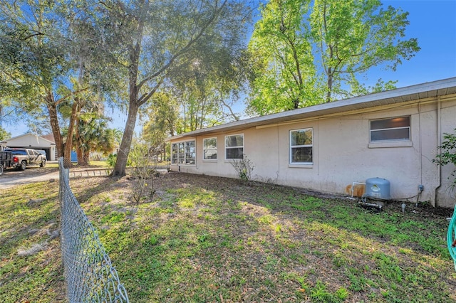 exterior space with fence and stucco siding