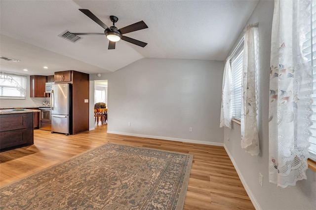 651 W Lake Brantley Rd, Altamonte Springs, FL 32714 - unfurnished living room featuring ceiling fan, light wood-style flooring, baseboards, plenty of natural light, and vaulted ceiling