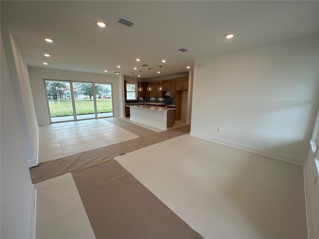 unfurnished living room featuring recessed lighting, visible vents, baseboards, and light tile patterned floors