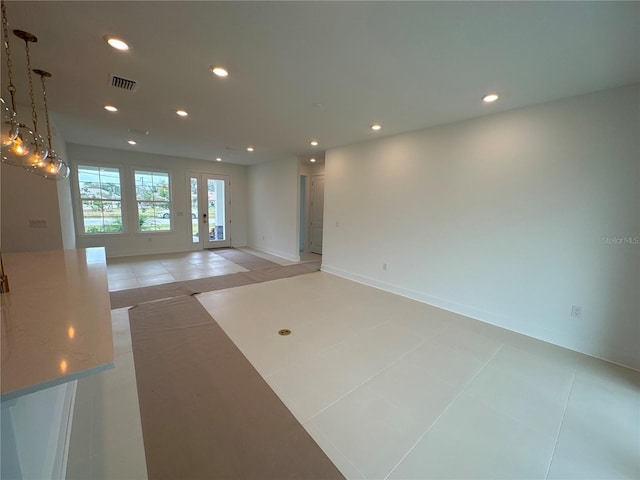 spare room with light tile patterned floors, visible vents, baseboards, recessed lighting, and french doors