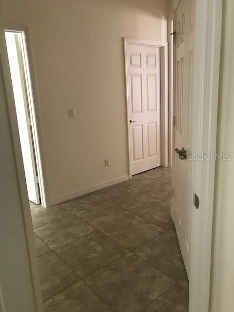 hallway featuring baseboards