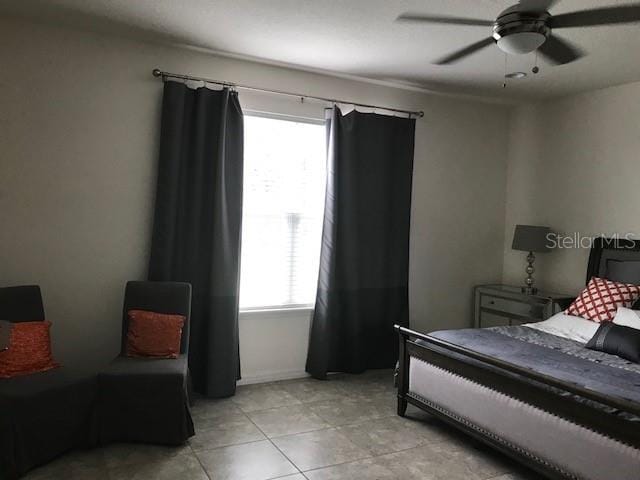 bedroom featuring light tile patterned floors and ceiling fan