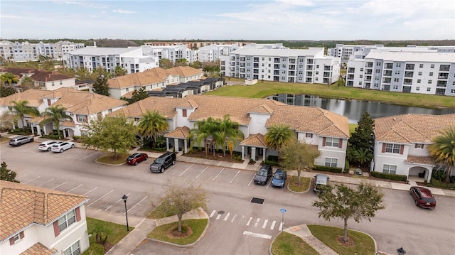 drone / aerial view featuring a water view and a residential view