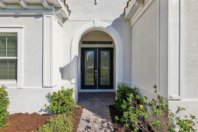 property entrance with stucco siding