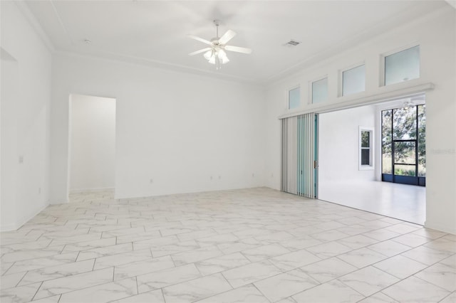 unfurnished room with ornamental molding, marble finish floor, visible vents, and ceiling fan