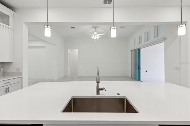 kitchen featuring open floor plan, a sink, and light countertops