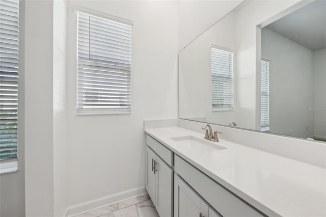 bathroom featuring marble finish floor, vanity, and baseboards