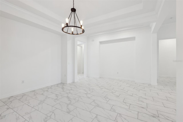 empty room with a notable chandelier, baseboards, marble finish floor, a raised ceiling, and crown molding