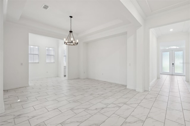 spare room featuring visible vents, a raised ceiling, an inviting chandelier, marble finish floor, and french doors