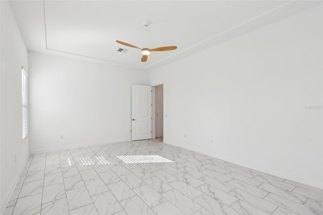 unfurnished room featuring ceiling fan, marble finish floor, visible vents, and baseboards