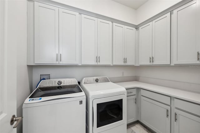 washroom with marble finish floor, cabinet space, and separate washer and dryer