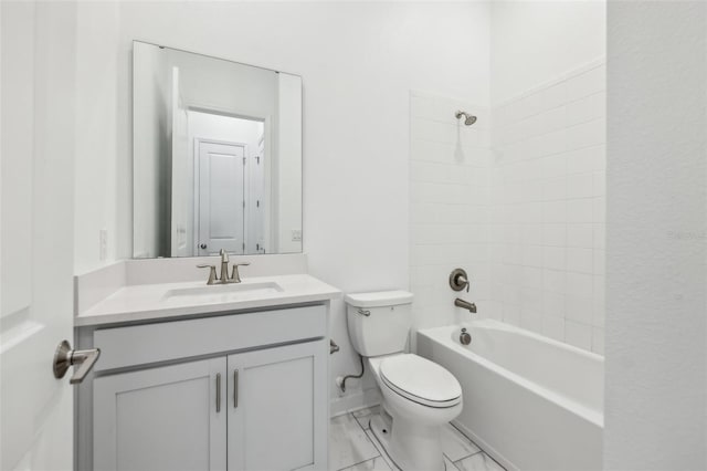 full bathroom with toilet, marble finish floor, washtub / shower combination, and vanity