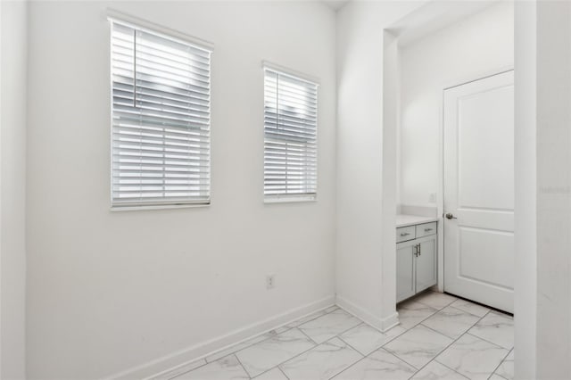 interior space with marble finish floor and baseboards