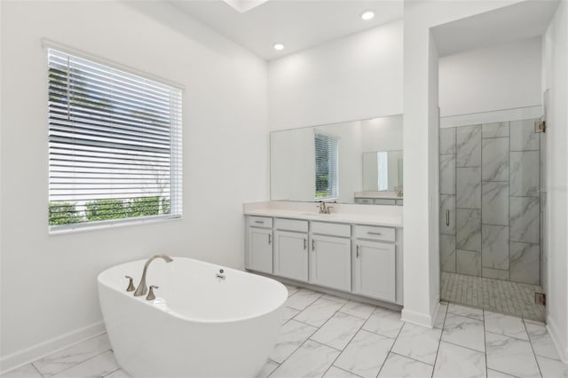 full bath with vanity, baseboards, a freestanding bath, marble finish floor, and a shower stall