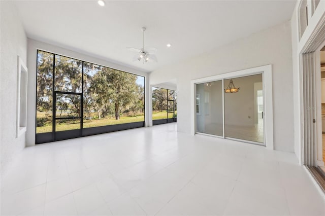 unfurnished sunroom with ceiling fan