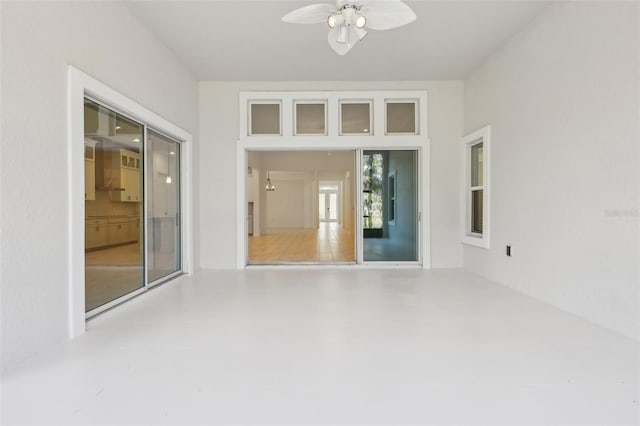 interior space with ceiling fan