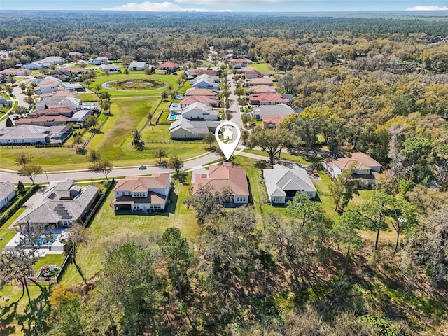 birds eye view of property featuring a residential view and a wooded view