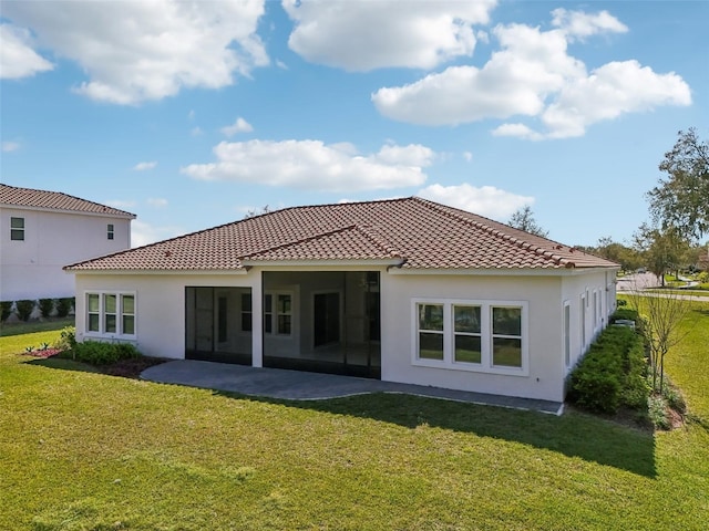 back of property with a patio, a lawn, a tile roof, and stucco siding