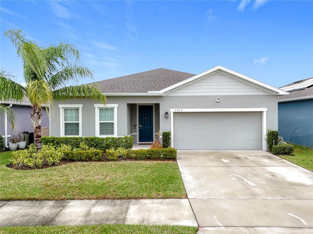 ranch-style home with roof with shingles, stucco siding, a front yard, a garage, and driveway