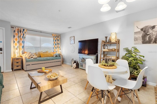 living room with baseboards and light tile patterned floors