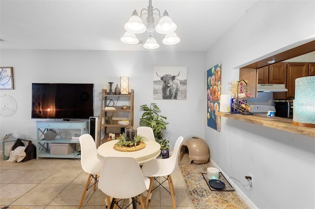 dining room featuring light tile patterned floors, a chandelier, and baseboards