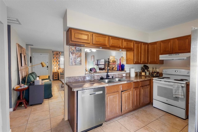 kitchen featuring white electric stove, brown cabinetry, dishwasher, under cabinet range hood, and a sink