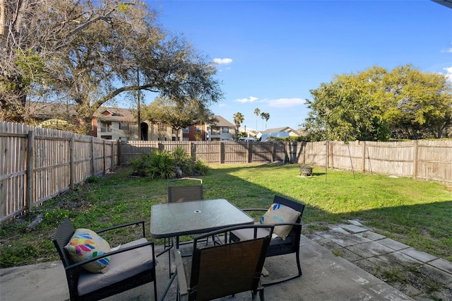 view of patio with outdoor dining space and a fenced backyard