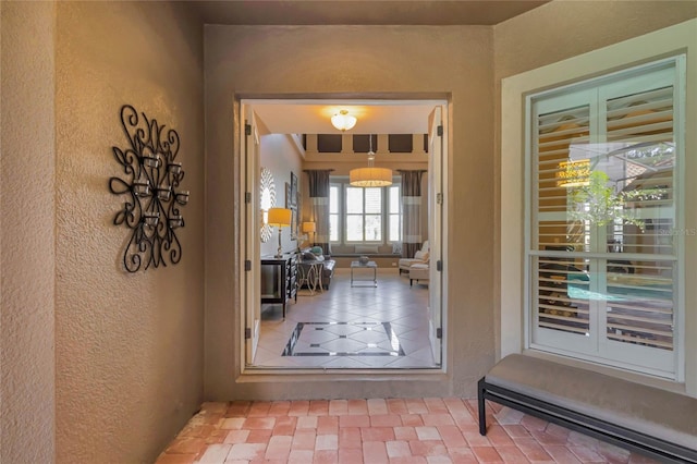 doorway to outside featuring a textured wall