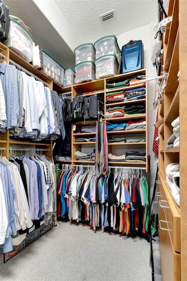 walk in closet featuring carpet floors and visible vents