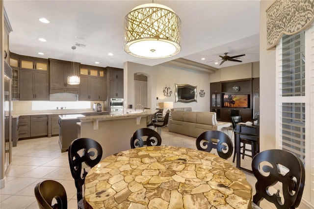 dining space featuring arched walkways, recessed lighting, visible vents, light tile patterned flooring, and ceiling fan