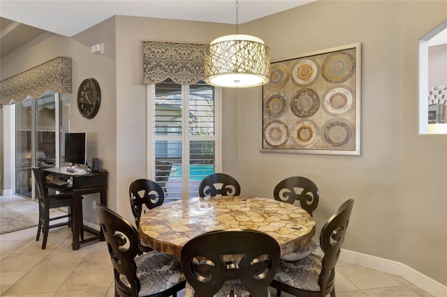 dining area featuring baseboards and light tile patterned floors