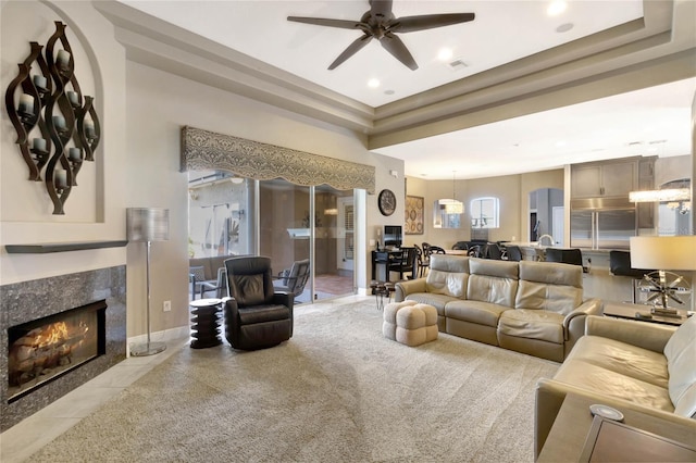 living area featuring baseboards, visible vents, ceiling fan, a fireplace, and recessed lighting