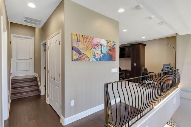 hall featuring baseboards, dark wood-type flooring, visible vents, and recessed lighting