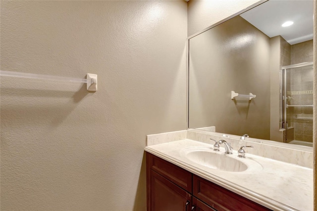 full bath with recessed lighting, a shower stall, and vanity