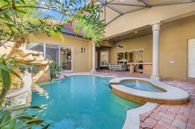 view of pool with a pool with connected hot tub, a patio area, and a ceiling fan