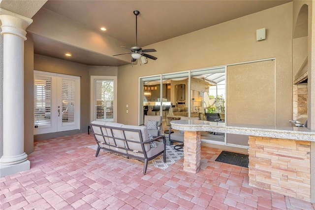 view of patio featuring ceiling fan, an outdoor living space, and french doors