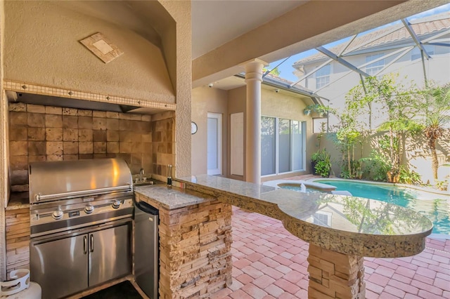 view of patio with a fenced in pool, glass enclosure, a grill, exterior kitchen, and a sink