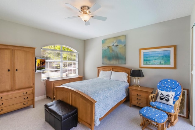 bedroom featuring light carpet, ceiling fan, and baseboards