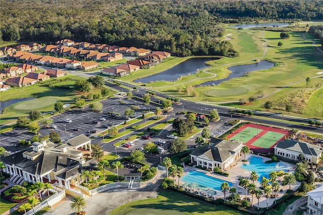 aerial view featuring golf course view, a water view, and a residential view