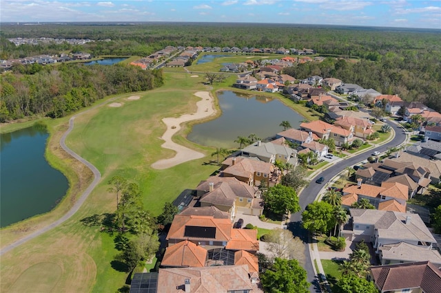 bird's eye view with a residential view, a water view, a view of trees, and golf course view