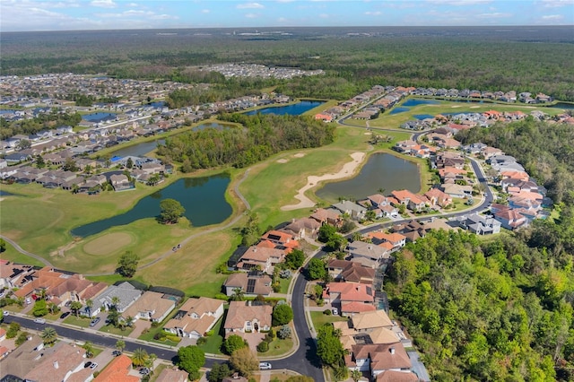 birds eye view of property with a water view, view of golf course, a residential view, and a view of trees